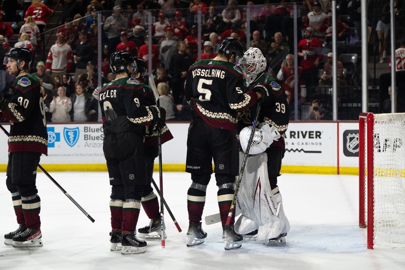 Mar 8, 2024; Tempe, Arizona, USA; Arizona Coyotes goalie Connor Ingram (39) celebrates with teammates including defensemen Michael Kesselring (5) and forward Clayton Keller (9) after a shutout against the Detroit Red Wings at Mullett Arena. Mandatory Credit: Allan Henry-USA TODAY Sports