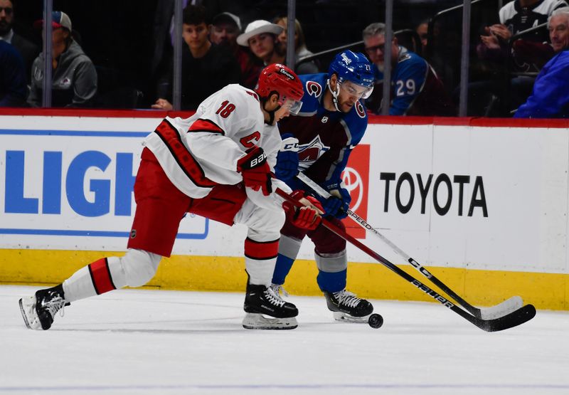 Oct 21, 2023; Denver, Colorado, USA; Carolina Hurricanes center Jack Drury (18) and Colorado Avalanche left wing Jonathan Drouin (27) chase after the puck in the first period  at Ball Arena. Mandatory Credit: John Leyba-USA TODAY Sports