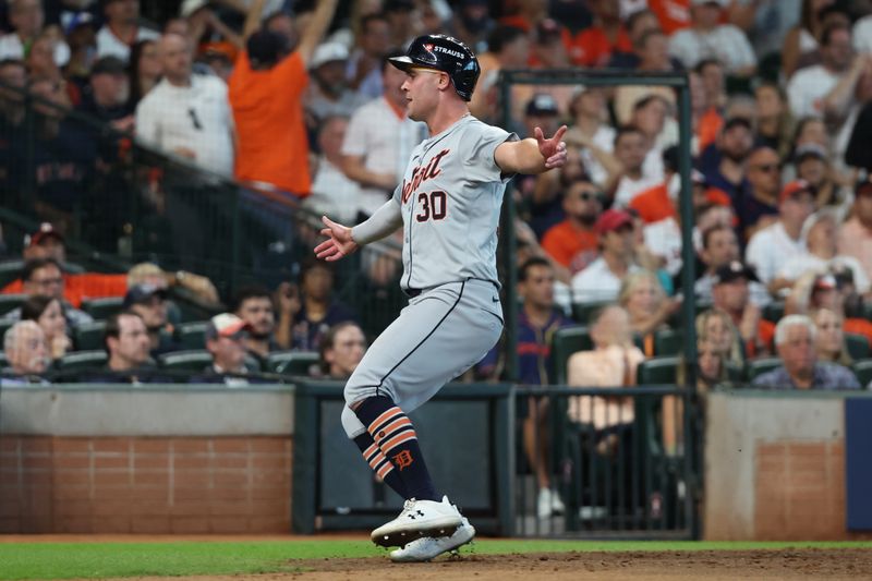 Oct 2, 2024; Houston, Texas, USA; Detroit Tigers outfielder Kerry Carpenter (30) scores a run against the Houston Astros during the eighth inning of game two of the Wildcard round for the 2024 MLB Playoffs at Minute Maid Park. Mandatory Credit: Thomas Shea-Imagn Images