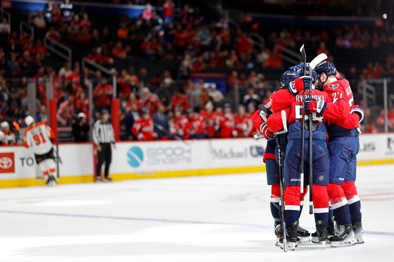 Sep 22, 2024; Washington, District of Columbia, USA; Washington Capitals defenseman Andrew Cristall (28) celebrates with teammates after scoring a goal against the Philadelphia Flyers in the first period at Capital One Arena. Mandatory Credit: Geoff Burke-Imagn Images