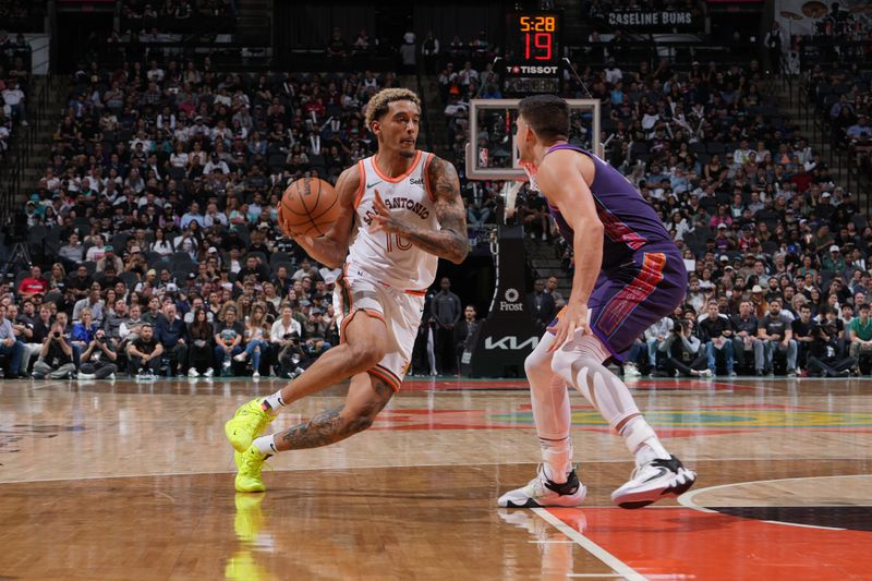 SAN ANTONIO, TX - MARCH 25: Jeremy Sochan #10 of the San Antonio Spurs dribbles the ball during the game against the Phoenix Suns on March 25, 2024 at the AT&T Center in San Antonio, Texas. NOTE TO USER: User expressly acknowledges and agrees that, by downloading and or using this photograph, user is consenting to the terms and conditions of the Getty Images License Agreement. Mandatory Copyright Notice: Copyright 2024 NBAE (Photos by Jesse D. Garrabrant/NBAE via Getty Images)