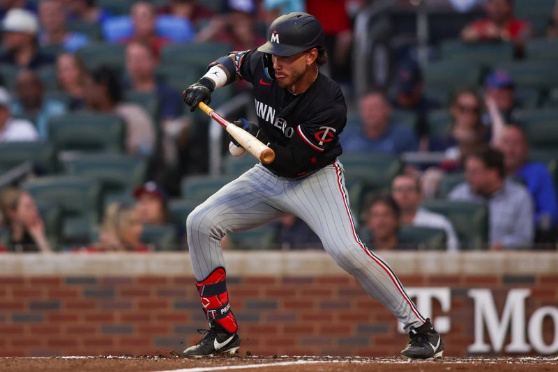 Apr 19, 2025; Atlanta, Georgia, USA; Minnesota Twins right fielder DaShawn Keirsey Jr. (21) has a ball hit his hand on a bunt attempt against the Atlanta Braves in the third inning at Truist Park. Mandatory Credit: Brett Davis-Imagn Images