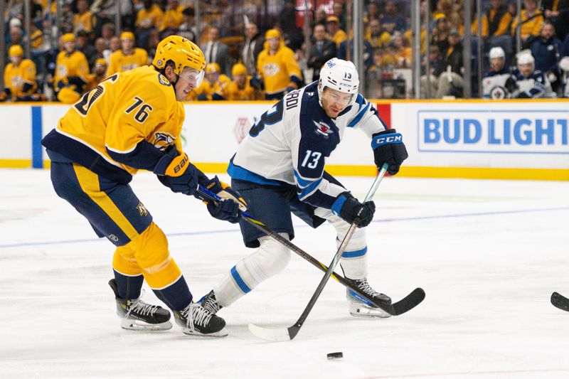 Nov 23, 2024; Nashville, Tennessee, USA;  Nashville Predators defenseman Brady Skjei (76) and Winnipeg Jets center Gabriel Vilardi (13) fight for the puck during the second period at Bridgestone Arena. Mandatory Credit: Steve Roberts-Imagn Images