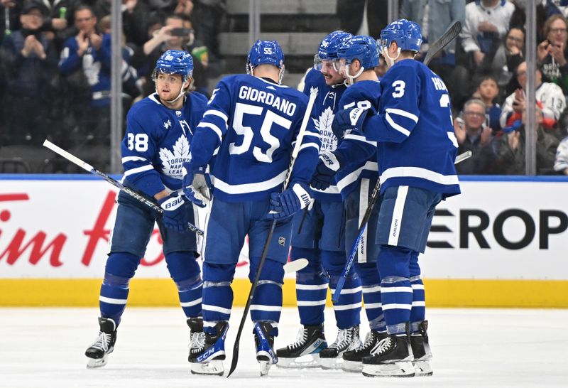 Jan 3, 2023; Toronto, Ontario, CAN; Toronto Maple Leafs forward William Nylander (88) celebrates a goal against the St. Louis Blues in the second period that also provided the 500th career point for forward Auston Matthews (34, center) at Scotiabank Arena. Mandatory Credit: Dan Hamilton-USA TODAY Sports