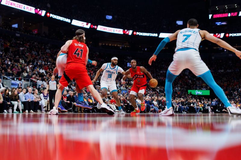 TORONTO, CANADA - MARCH 3: Immanuel Quickley #5 of the Toronto Raptors drives around Marques Bolden #3 of the Charlotte Hornets in the first half of their NBA game at Scotiabank Arena on March 3, 2024 in Toronto, Canada. NOTE TO USER: User expressly acknowledges and agrees that, by downloading and or using this photograph, User is consenting to the terms and conditions of the Getty Images License Agreement. (Photo by Cole Burston/Getty Images)