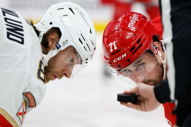 Mar 2, 2024; Detroit, Michigan, USA; Florida Panthers center Kevin Stenlund (82) and Detroit Red Wings center Dylan Larkin (71) get set during a face off in the second period at Little Caesars Arena. Mandatory Credit: Rick Osentoski-USA TODAY Sports