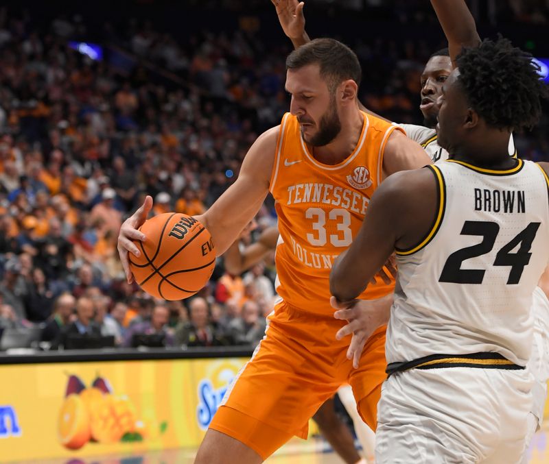 Mar 10, 2023; Nashville, TN, USA;  Tennessee Volunteers forward Uros Plavsic (33) drives the baseline as Missouri Tigers guard Kobe Brown (24) defends during the first half at Bridgestone Arena. Mandatory Credit: Steve Roberts-USA TODAY Sports