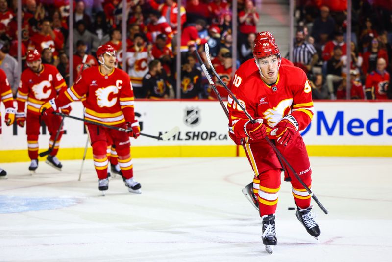 Oct 15, 2024; Calgary, Alberta, CAN; Calgary Flames left wing Andrei Kuzmenko (96) celebrates his goal with teammates against the Chicago Blackhawks during the second period at Scotiabank Saddledome. Mandatory Credit: Sergei Belski-Imagn Images