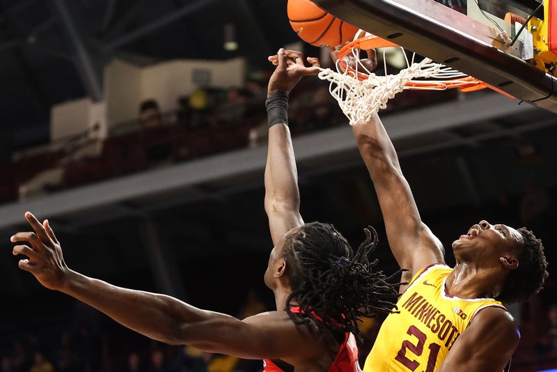 Mar 2, 2023; Minneapolis, Minnesota, USA; Rutgers Scarlet Knights center Clifford Omoruyi (11) blocks a shot by Minnesota Golden Gophers forward Pharrel Payne (21) during the first half at Williams Arena. Mandatory Credit: Matt Krohn-USA TODAY Sports