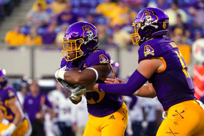 Sep 25, 2021; Greenville, North Carolina, USA; East Carolina Pirates running back Keaton Mitchell (25) scores a first half touchdown against the Charleston Southern Buccaneers at Dowdy-Ficklen Stadium. Mandatory Credit: James Guillory-USA TODAY Sports