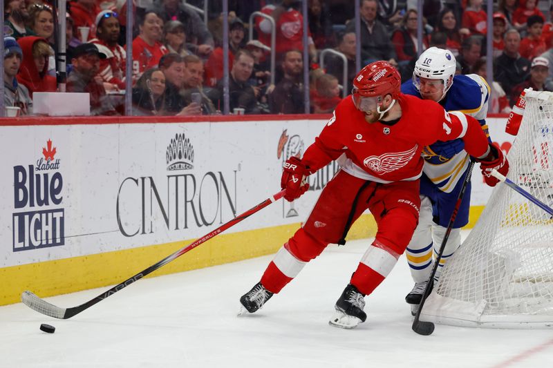 Apr 7, 2024; Detroit, Michigan, USA; Detroit Red Wings center Andrew Copp (18) skates with the puck chased by Buffalo Sabres defenseman Henri Jokiharju (10) in the second period at Little Caesars Arena. Mandatory Credit: Rick Osentoski-USA TODAY Sports