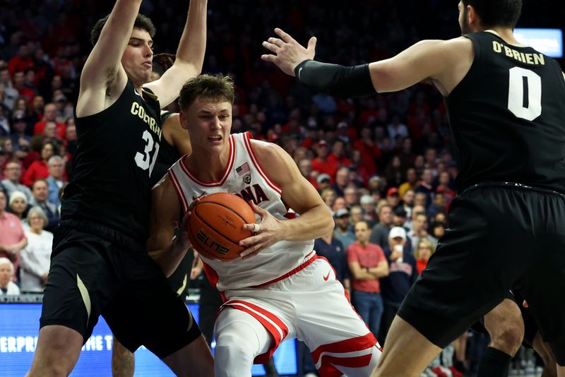 Jan 4, 2024; Tucson, Arizona, USA; Arizona Wildcats guard Pelle Larsson (3) drives to the net against Colorado Buffaloes guard Harrison Carrington (31) during the second half at McKale Center. Mandatory Credit: Zachary BonDurant-USA TODAY Sports