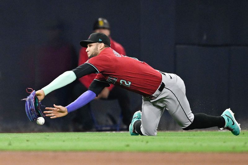 Jun 6, 2024; San Diego, California, USA; Arizona Diamondbacks left fielder Lourdes Gurriel Jr. (12) can’t make the catch on a double hit by San Diego Padres first baseman Jake Cronenworth (9) during the fifth inning at Petco Park. Mandatory Credit: Denis Poroy-USA TODAY Sports at Petco Park. 