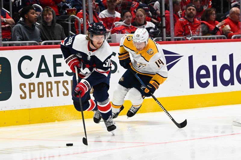 Dec 30, 2023; Washington, District of Columbia, USA; Washington Capitals defenseman Rasmus Sandin (38) advances the puck as Nashville Predators center Gustav Nyquist (14) chases during the second period at Capital One Arena. Mandatory Credit: Brad Mills-USA TODAY Sports