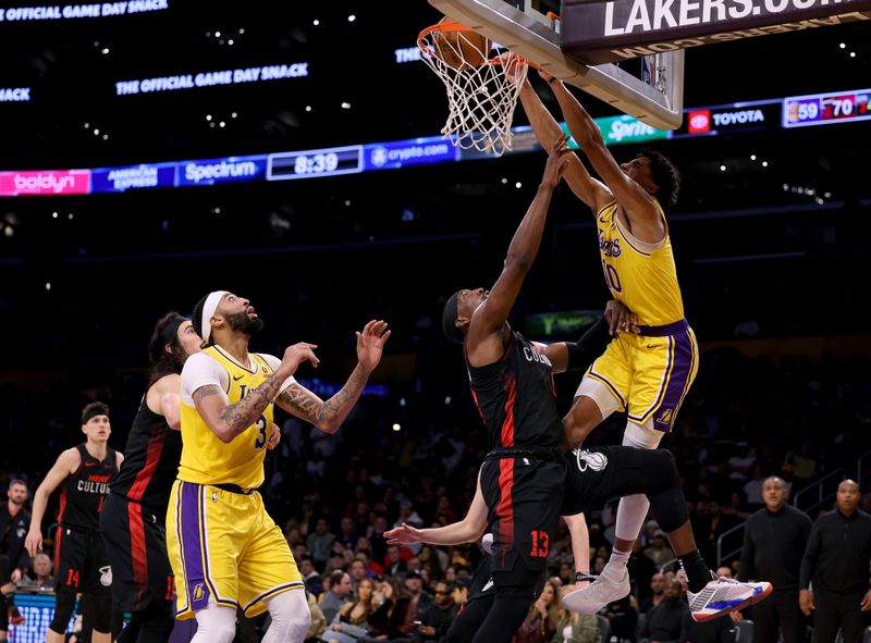 LOS ANGELES, CALIFORNIA - JANUARY 03: Max Christie #10 of the Los Angeles Lakers dunks over Bam Adebayo #13 of the Miami Heat during a 110-96 Heat win at Crypto.com Arena on January 03, 2024 in Los Angeles, California. (Photo by Harry How/Getty Images)