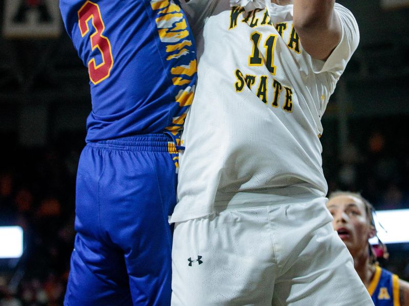 Jan 14, 2023; Wichita, Kansas, USA; Wichita State Shockers forward Kenny Pohto (11) puts up a shot around Tulsa Golden Hurricane guard Sterling Gaston-Chapman (3) during the second half at Charles Koch Arena. Mandatory Credit: William Purnell-USA TODAY Sports