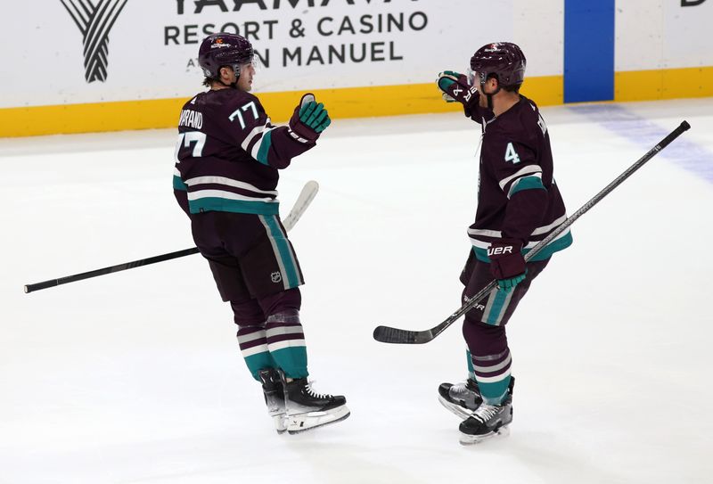 Nov 12, 2023; Anaheim, California, USA; Anaheim Ducks right wing Frank Vatrano (77) celebrates with defenseman Cam Fowler (4) after scoring during the first period against the San Jose Sharks at Honda Center. Mandatory Credit: Jason Parkhurst-USA TODAY Sports