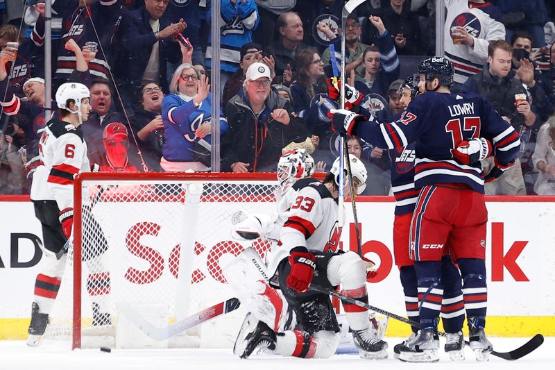 Apr 2, 2023; Winnipeg, Manitoba, CAN; Winnipeg Jets right wing Nino Niederreiter (62) celebrates his first period goal with Winnipeg Jets center Adam Lowry (17) against the New Jersey Devils at Canada Life Centre. Mandatory Credit: James Carey Lauder-USA TODAY Sports