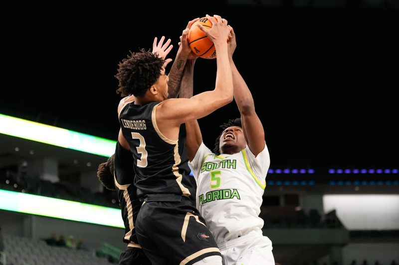 Mar 16, 2024; Fort Worth, TX, USA;  South Florida Bulls guard Brandon Stroud (5) and UAB Blazers forward Yaxel Lendeborg (3) battle for the rebound during the first half at Dickies Arena. Mandatory Credit: Chris Jones-USA TODAY Sports