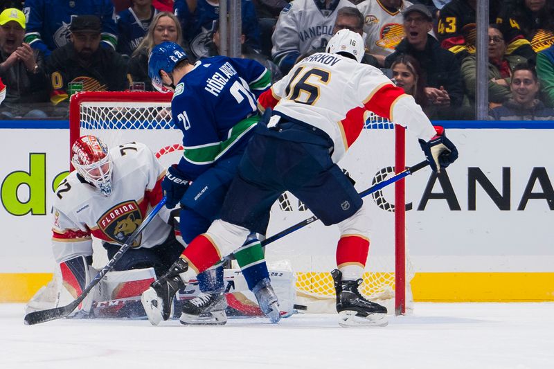 Dec 14, 2023; Vancouver, British Columbia, CAN; Florida Panthers goalie Sergei Bobrovsky (72) makes a save on Vancouver Canucks forward Nils Hoglander (21) as forward Aleksander Barkov (16) watches the rebound in the first period at Rogers Arena. Mandatory Credit: Bob Frid-USA TODAY Sports