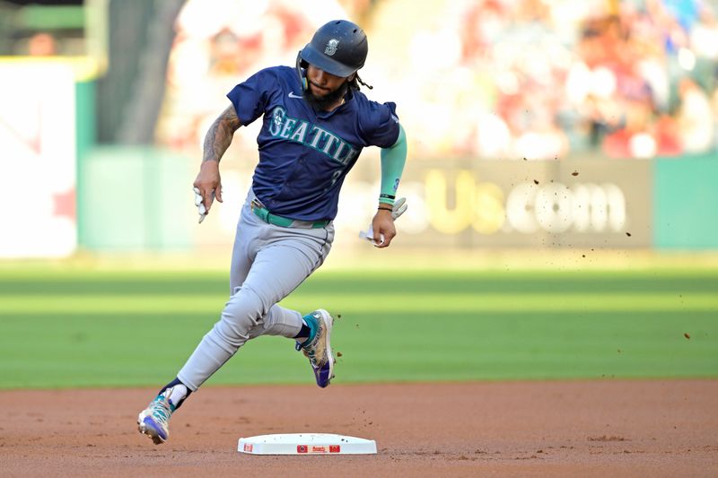 Jul 13, 2024; Anaheim, California, USA;  J.P. Crawford #3 of the Seattle Mariners advances to third on a single by Cal Raleigh #29 in the first inning against the Los Angeles Angels at Angel Stadium. Mandatory Credit: Jayne Kamin-Oncea-USA TODAY Sports