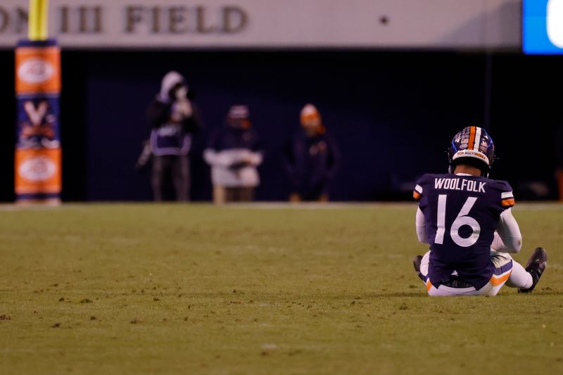 Nov 13, 2021; Charlottesville, Virginia, USA; Virginia Cavaliers quarterback Jay Woolfolk (16) sits on the field after an incomplete pass against the Notre Dame Fighting Irish during the third quarter at Scott Stadium. Mandatory Credit: Geoff Burke-USA TODAY Sports