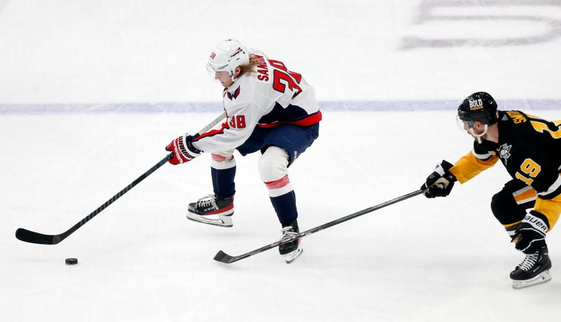 Mar 7, 2024; Pittsburgh, Pennsylvania, USA; Washington Capitals defenseman Rasmus Sandin (38) skates with the puck as Pittsburgh Penguins right wing Reilly Smith (19) defends during the third period at PPG Paints Arena. The Capitals shutout the Penguins 6-0. Mandatory Credit: Charles LeClaire-USA TODAY Sports