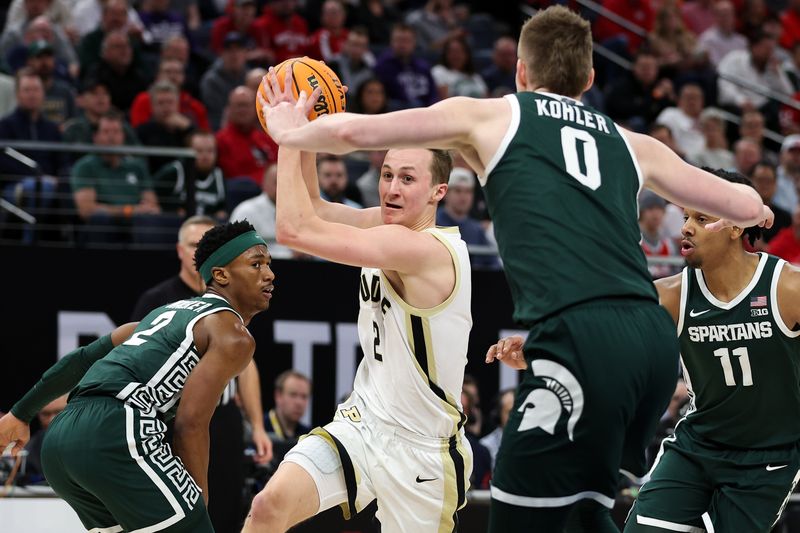 Mar 15, 2024; Minneapolis, MN, USA; Purdue Boilermakers guard Fletcher Loyer (2) works through Michigan State Spartans guard Tyson Walker (2), guard A.J. Hoggard (11) and forward Jaxon Kohler (0) during the first half at Target Center. Mandatory Credit: Matt Krohn-USA TODAY Sports