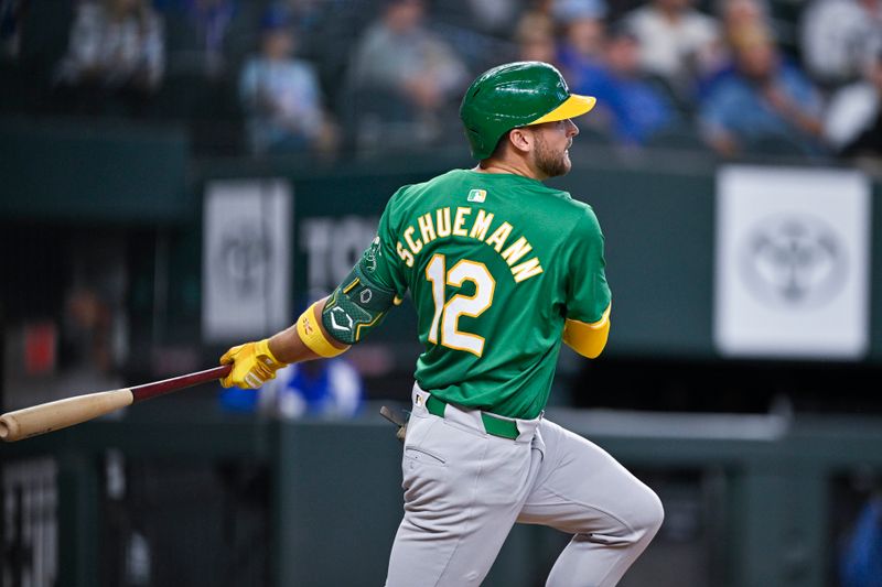 Sep 1, 2024; Arlington, Texas, USA; Oakland Athletics third baseman Max Schuemann (12) hits a single and drives in the tying run against the Texas Rangers during the eighth inning at Globe Life Field. Mandatory Credit: Jerome Miron-USA TODAY Sports