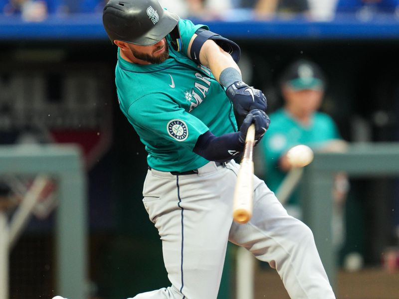 Jun 7, 2024; Kansas City, Missouri, USA; Seattle Mariners right fielder Mitch Haniger (17) hits a three run double during the first inning against the Kansas City Royals at Kauffman Stadium. Mandatory Credit: Jay Biggerstaff-USA TODAY Sports