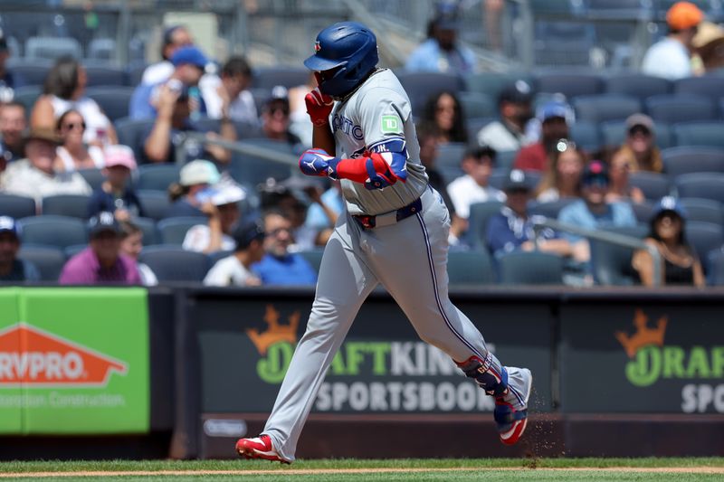 Aug 3, 2024; Bronx, New York, USA; Toronto Blue Jays first baseman Vladimir Guerrero Jr. (27) gestures as he rounds the bases after hitting a solo home run against the New York Yankees during the first inning at Yankee Stadium. Mandatory Credit: Brad Penner-USA TODAY Sports