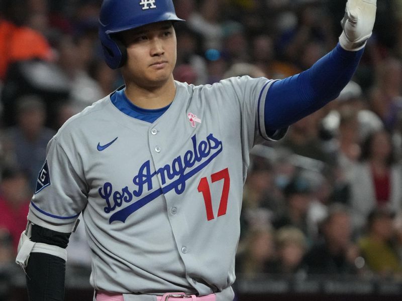 May 11, 2025; Phoenix, Arizona, USA; Los Angeles Dodgers Shohei Ohtani (17) reacts while hitting against the Arizona Diamondbacks in the ninth inning at Chase Field. Mandatory Credit: Rick Scuteri-Imagn Images