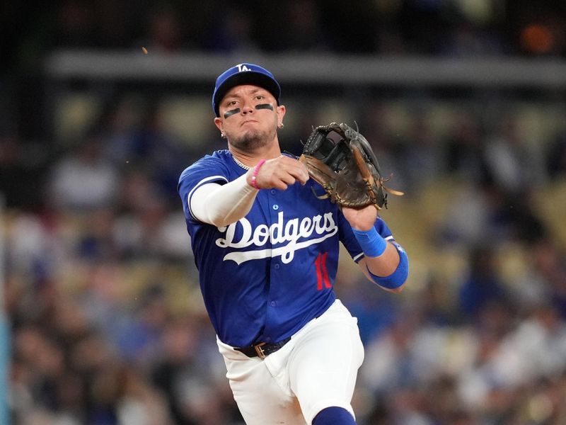 Mar 25, 2024; Los Angeles, California, USA; Los Angeles Dodgers shortstop Miguel Rojas (11) throws to first base in the fourth inning against the Los Angeles Angels at Dodger Stadium. Mandatory Credit: Kirby Lee-USA TODAY Sports