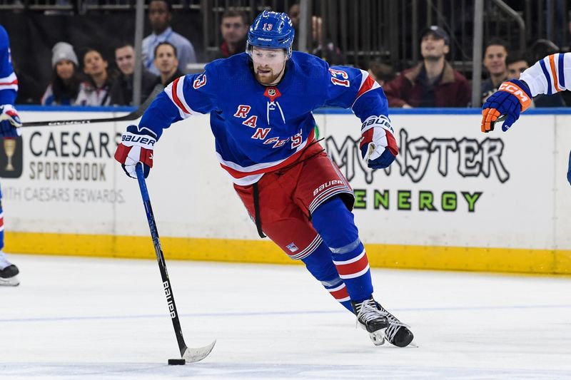 Dec 22, 2023; New York, New York, USA;  New York Rangers left wing Alexis Lafreniere (13) skates with the puck against the Edmonton Oilers during the second period at Madison Square Garden. Mandatory Credit: Dennis Schneidler-USA TODAY Sports