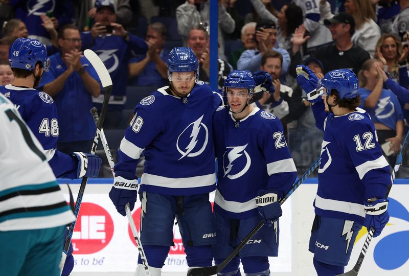 Oct 26, 2023; Tampa, Florida, USA; Tampa Bay Lightning center Brayden Point (21) is congratulated after he scored a goal against the San Jose Sharks during the first period at Amalie Arena. Mandatory Credit: Kim Klement Neitzel-USA TODAY Sports