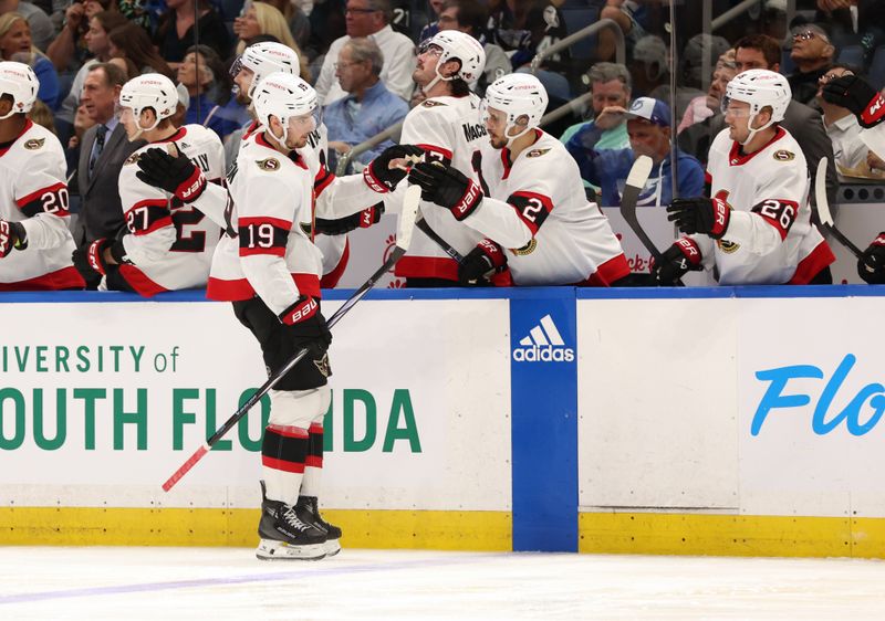 Apr 11, 2024; Tampa, Florida, USA; Ottawa Senators right wing Drake Batherson (19) is congratulated after he scored a goal against the Tampa Bay Lightning during the third period at Amalie Arena. Mandatory Credit: Kim Klement Neitzel-USA TODAY Sports