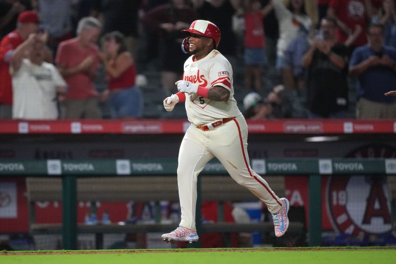 Jul 12, 2024; Anaheim, California, USA; Los Angeles Angels designated hitter Willie Calhoun (5) runs the bases after hitting a two-run walkoff home run in the 10th inning against the Seattle Mariners at Angel Stadium. Mandatory Credit: Kirby Lee-USA TODAY Sports