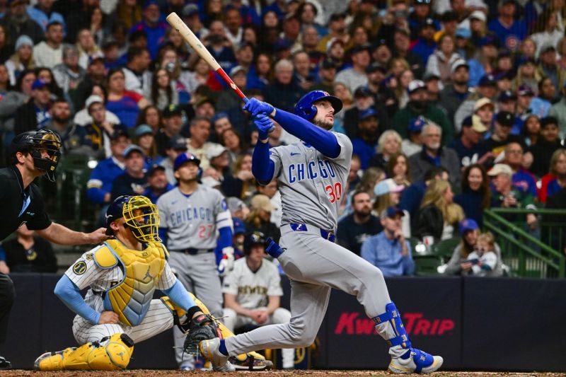 May 3, 2025; Milwaukee, Wisconsin, USA; Chicago Cubs right fielder Kyle Tucker (30) hits a solo home run in the fifth inning as Milwaukee Brewers catcher William Contreras (24) looks on at American Family Field. Mandatory Credit: Benny Sieu-Imagn Images
