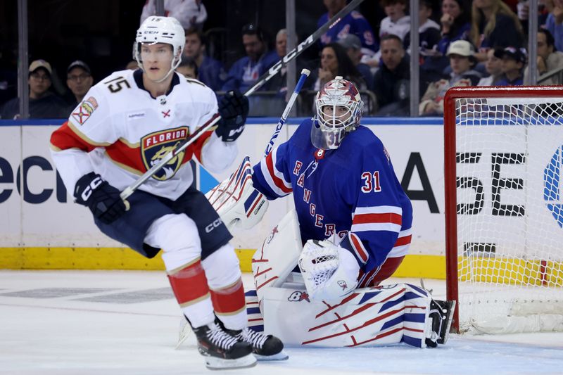 May 22, 2024; New York, New York, USA; New York Rangers goaltender Igor Shesterkin (31) and Florida Panthers center Anton Lundell (15) follow the puck during the second period of game one of the Eastern Conference Final of the 2024 Stanley Cup Playoffs at Madison Square Garden. Mandatory Credit: Brad Penner-USA TODAY Sports