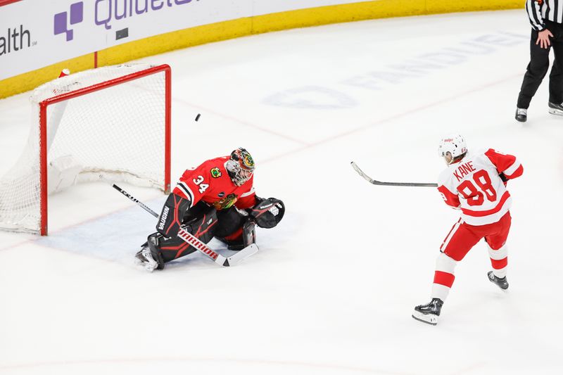 Feb 25, 2024; Chicago, Illinois, USA; Detroit Red Wings right wing Patrick Kane (88) shoots and scores game winning goal against Chicago Blackhawks goaltender Petr Mrazek (34) in overtime at United Center. Mandatory Credit: Kamil Krzaczynski-USA TODAY Sports