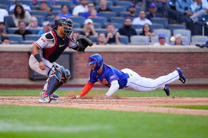 Sep 14, 2023; New York City, New York, USA; New York Mets first baseman Pete Alonso (20) dives safely into home plate ahead of the throw received by Arizona Diamondbacks catcher Gabriel Moreno (14) during the fifth inning at Citi Field. Mandatory Credit: Gregory Fisher-USA TODAY Sports