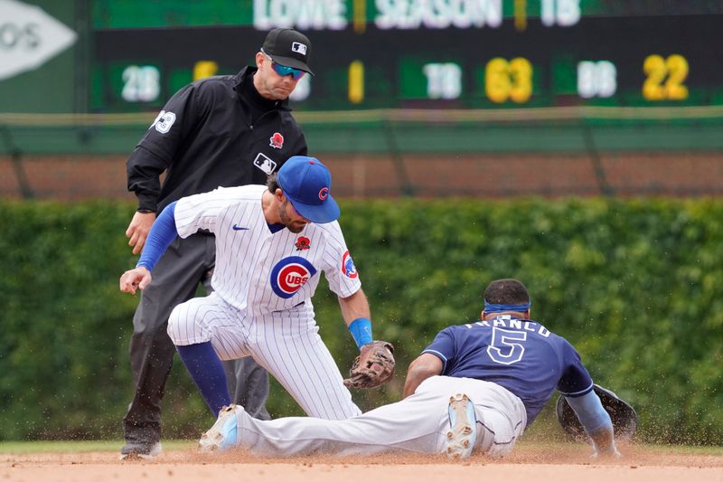 May 29, 2023; Chicago, Illinois, USA; Tampa Bay Rays shortstop Wander Franco (5) steals second base as Chicago Cubs shortstop Dansby Swanson (7) makes a late tag during the seventh inning at Wrigley Field. Mandatory Credit: David Banks-USA TODAY Sports