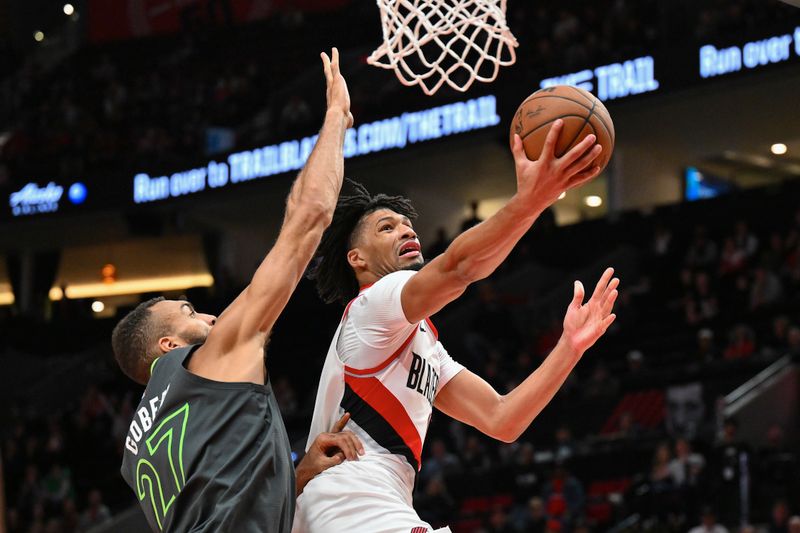 PORTLAND, OREGON - NOVEMBER 13: Shaedon Sharpe #17 of the Portland Trail Blazers drives to the basket against Rudy Gobert #27 of the Minnesota Timberwolves during the fourth quarter of the game at Moda Center on November 13, 2024 in Portland, Oregon. The Portland Trail Blazers won 106-98. NOTE TO USER: User expressly acknowledges and agrees that, by downloading and or using this photograph, User is consenting to the terms and conditions of the Getty Images License Agreement. (Photo by Alika Jenner/Getty Images)