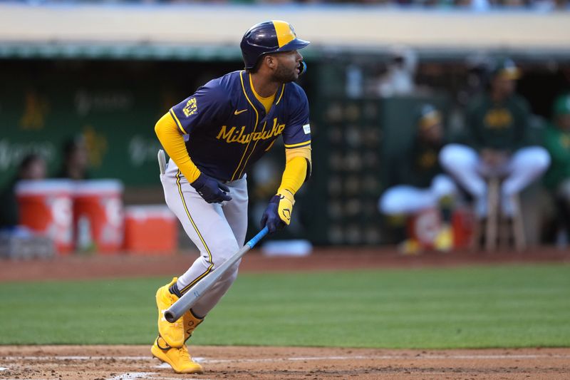 Aug 23, 2024; Oakland, California, USA; Milwaukee Brewers left fielder Jackson Chourio (11) hits an RBI single against the Oakland Athletics during the second inning at Oakland-Alameda County Coliseum. Mandatory Credit: Darren Yamashita-USA TODAY Sports