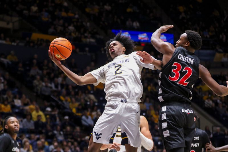 Jan 6, 2026; Morgantown, West Virginia, USA; West Virginia Mountaineers guard Amir Jenkins (2) shoots against Cincinnati Bearcats forward Jalen Celestine (32) during the second half at Hope Coliseum. Mandatory Credit: Ben Queen-Imagn Images