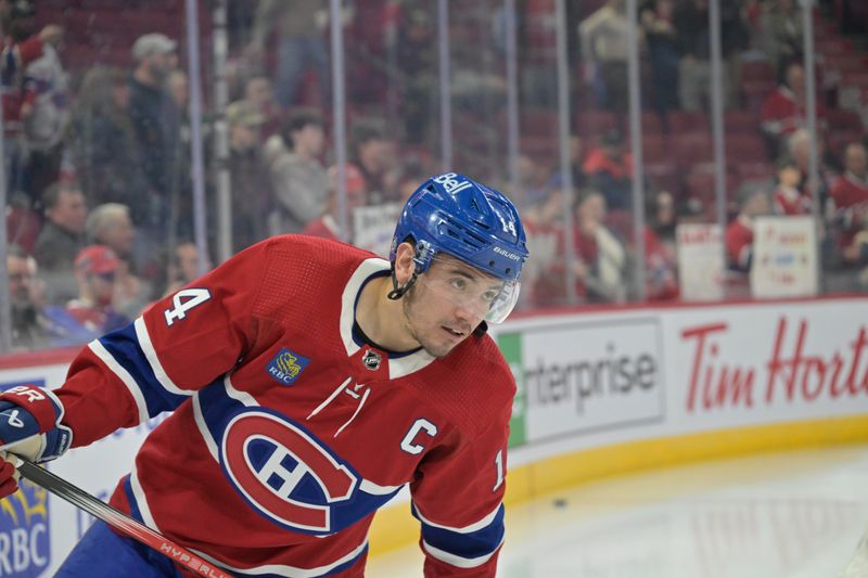 Apr 2, 2024; Montreal, Quebec, CAN; Montreal Canadiens forward Nick Suzuki (14) skates during the warmup period before the game against the Florida Panthers at the Bell Centre. Mandatory Credit: Eric Bolte-USA TODAY Sports