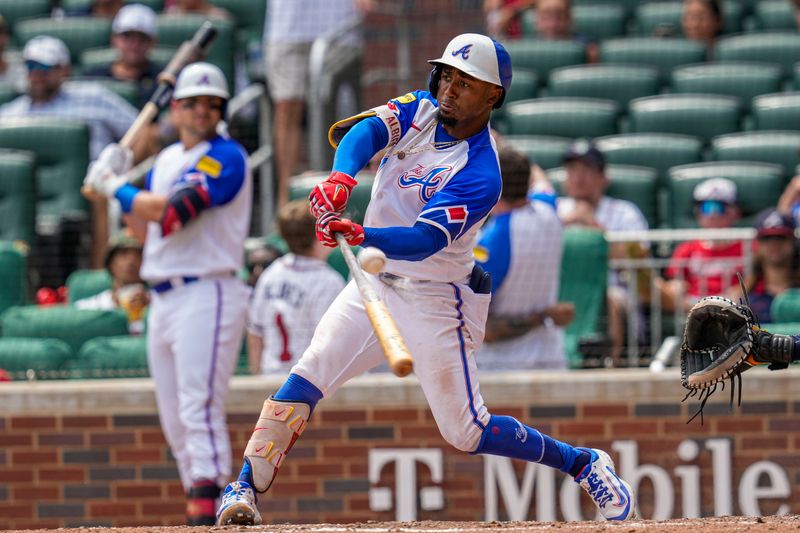 Jul 30, 2023; Cumberland, Georgia, USA; Atlanta Braves second baseman Ozzie Albies (1) hits a double against the Milwaukee Brewers during the eighth inning at Truist Park. Mandatory Credit: Dale Zanine-USA TODAY Sports