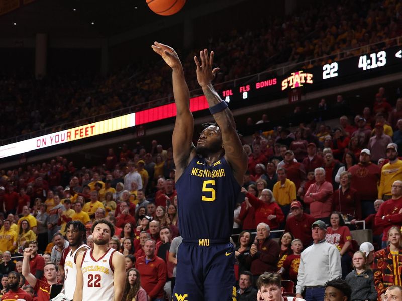 Feb 27, 2023; Ames, Iowa, USA; West Virginia Mountaineers guard Joe Toussaint (5) scores against the Iowa State Cyclones during the first half at James H. Hilton Coliseum. Mandatory Credit: Reese Strickland-USA TODAY Sports