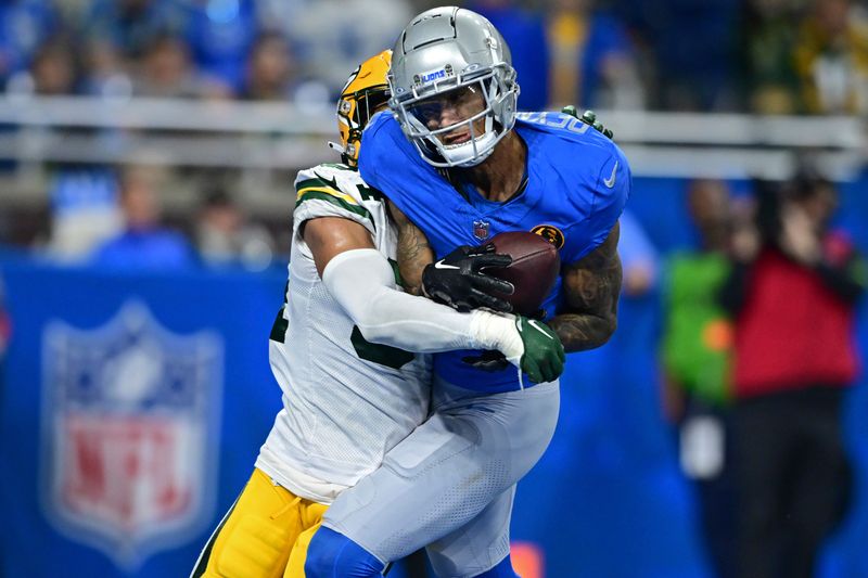 Detroit Lions wide receiver Josh Reynolds catches a touchdown against Green Bay Packers safety Jonathan Owens during the second half of an NFL football game, Thursday, Nov. 23, 2023, in Detroit. The Packers won 29-22. (AP Photo/David Dermer)