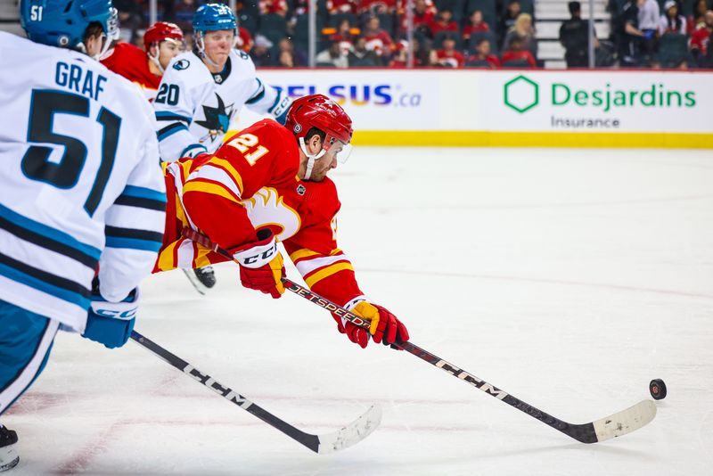 Apr 18, 2024; Calgary, Alberta, CAN; Calgary Flames center Kevin Rooney (21) controls the puck against the San Jose Sharks during the third period at Scotiabank Saddledome. Mandatory Credit: Sergei Belski-USA TODAY Sports